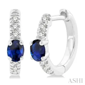 1/10 ctw Petite 4X3MM Oval Cut Sapphire and Round Cut Diamond Fashion Huggies in 10K White Gold